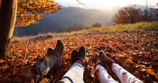 Low section of people on leaves during autumn