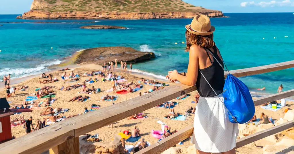 A tourist on Cala Comte beach on the island of Ibiza Sunset Balearic